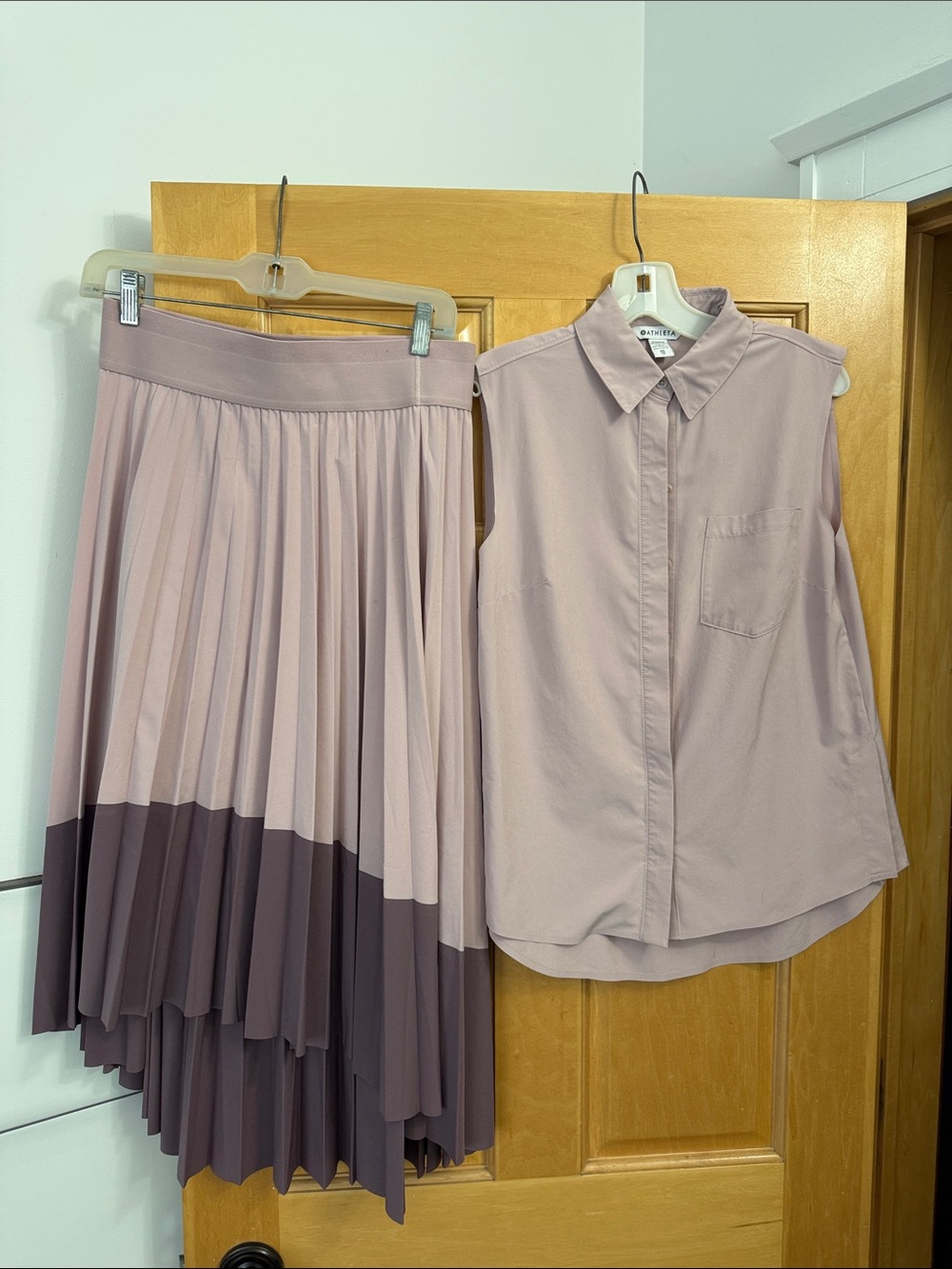 Athleta Two-Piece Asymmetrical Pleated Skirt Set in Dusty Mauve and Plum.